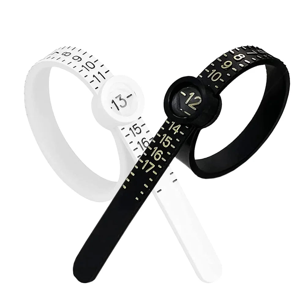 A black adjustable ring sizer with a white band and built-in magnifier tool.