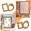 A collection of vintage gold mini picture frames in various sizes and shapes displayed on a wooden surface.