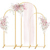 A set of three gold metal arched wedding backdrop stands with sheer pink draping.