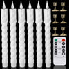 A set of white fluted LED taper candles with gold-colored stands and a remote control for timer and light.