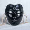 A black ancient style masquerade mask with intricate details and light beige ties.