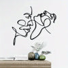 Black metal wall art featuring a modern silhouette of a cat and a woman against a white background.