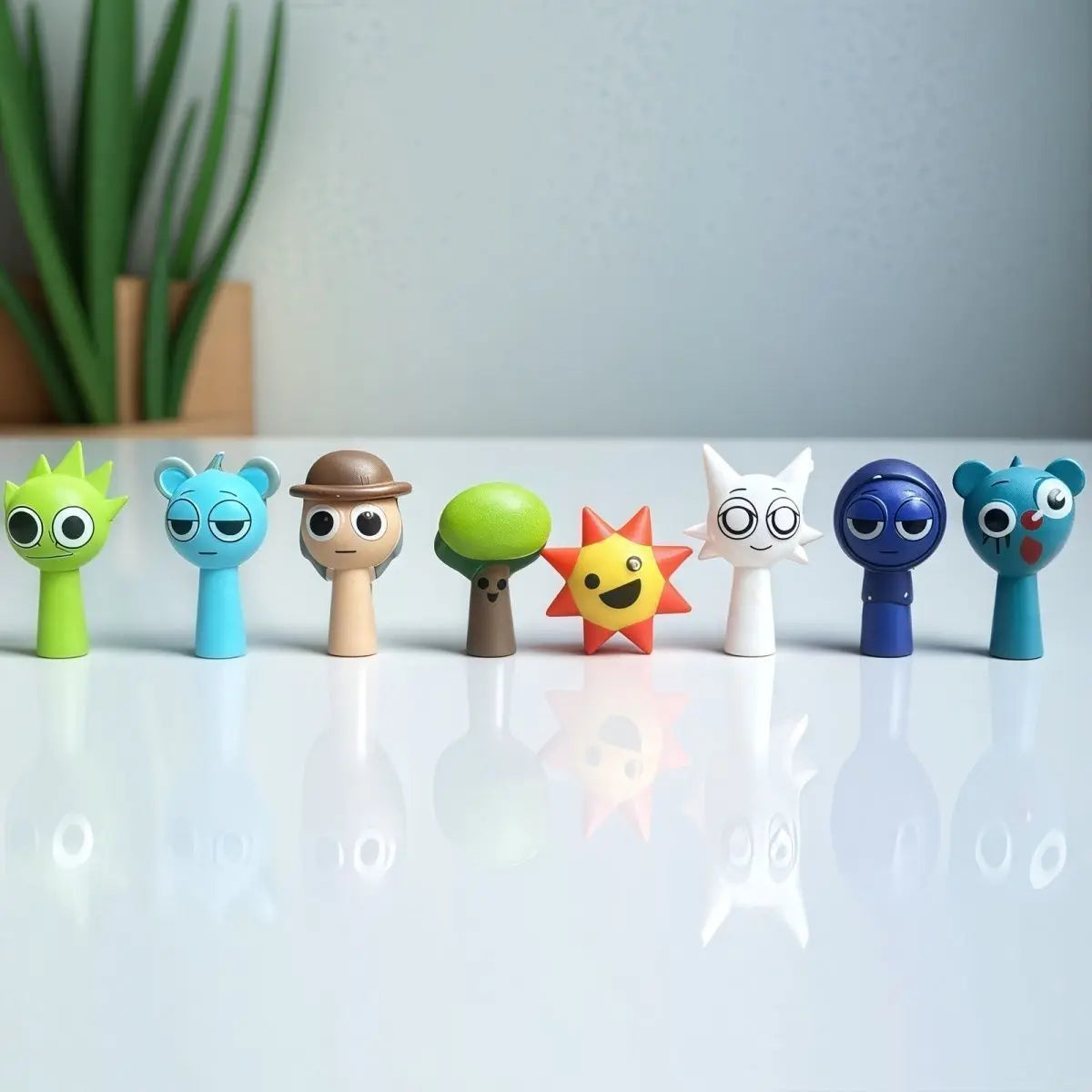 A collection of handcrafted musical figurines in various colors and shapes displayed on a white surface.