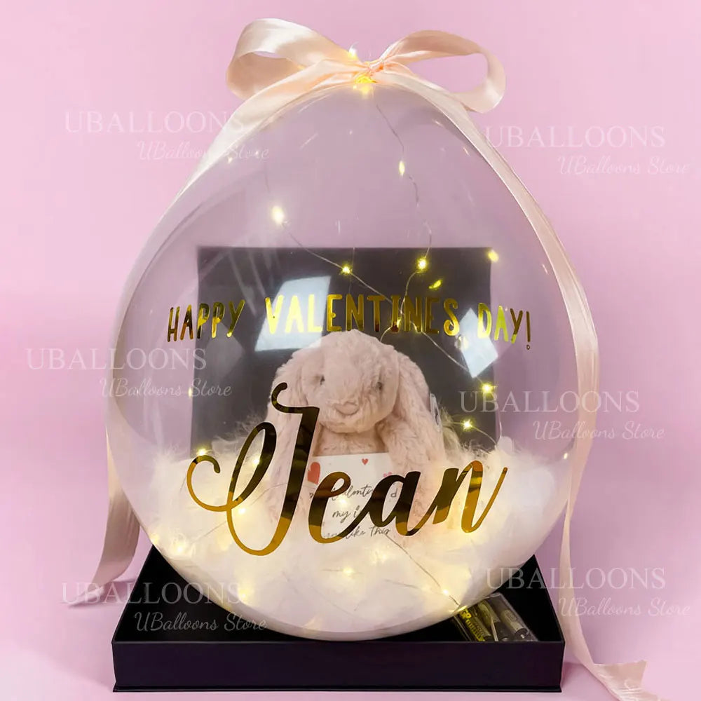 A clear balloon filled with white fluff and a message that reads Happy Valentine's Day