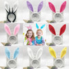 A collection of colorful bunny ear headbands in pink, purple, red, and blue for parties and cosplay.