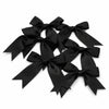 Black satin ribbon bows tied in decorative loops for gifts and crafts