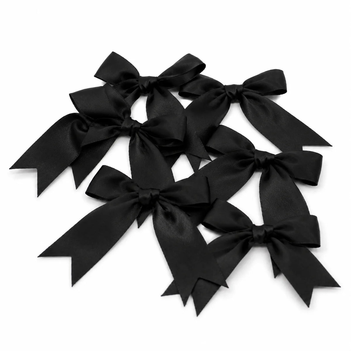 Black satin ribbon bows tied in decorative loops for gifts and crafts