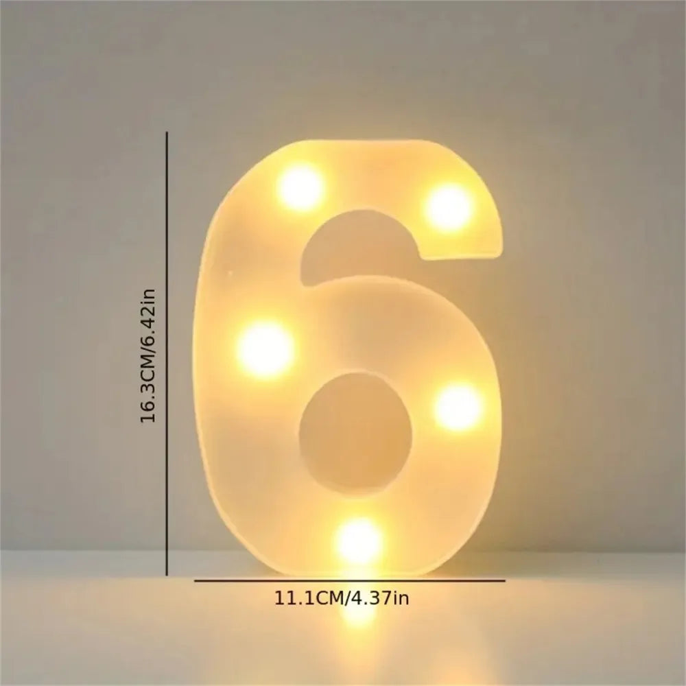 A glowing LED letter light shaped like the number six, illuminating a soft yellow light.