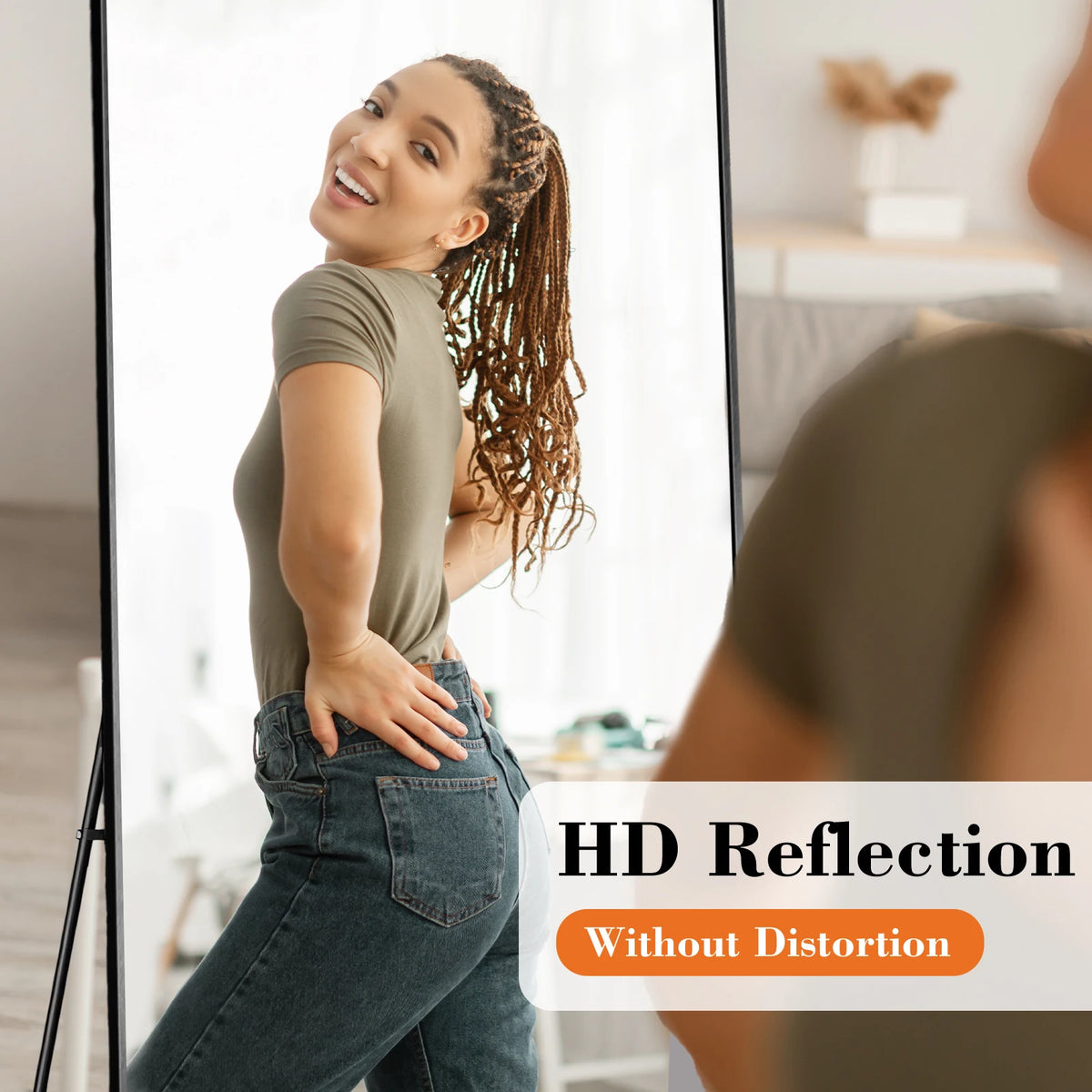 A woman is reflected in a full length arched wall mirror showing her outfit and face.