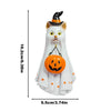 A white ghost figurine with a black witch hat and an orange carved pumpkin decoration.