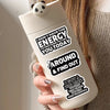 A white bottle with black text decals encouraging energy and finding out about a big secret.