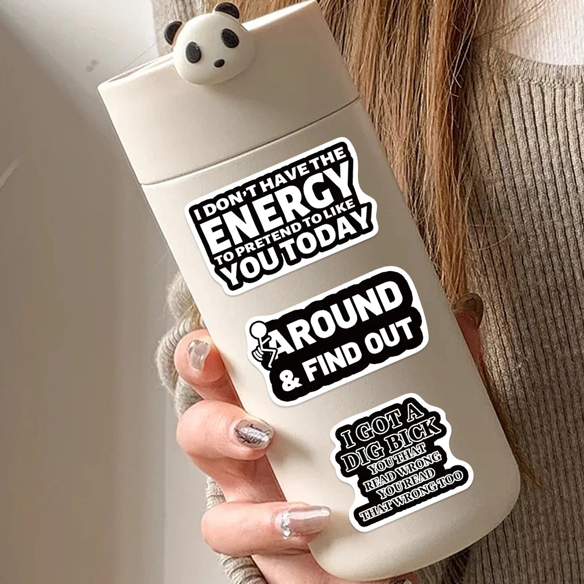 A white bottle with black text decals encouraging energy and finding out about a big secret.