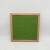 A wooden frame holds a green felt letter board with horizontal slits.