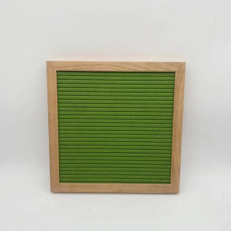 A wooden frame holds a green felt letter board with horizontal slits.