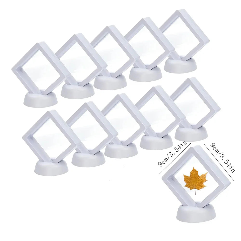 A set of ten white floating shadow box jewelry display frames with square openings and round bases.