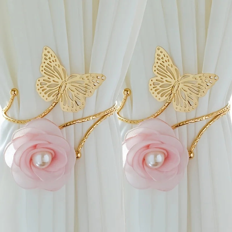 A set of two gold-toned decorative flower butterfly curtain tiebacks with pink roses and pearl accents.