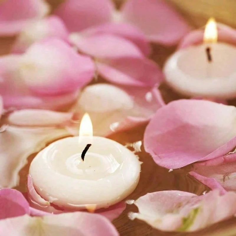 Pink rose petals surround glowing white floating candles for romantic home décor
