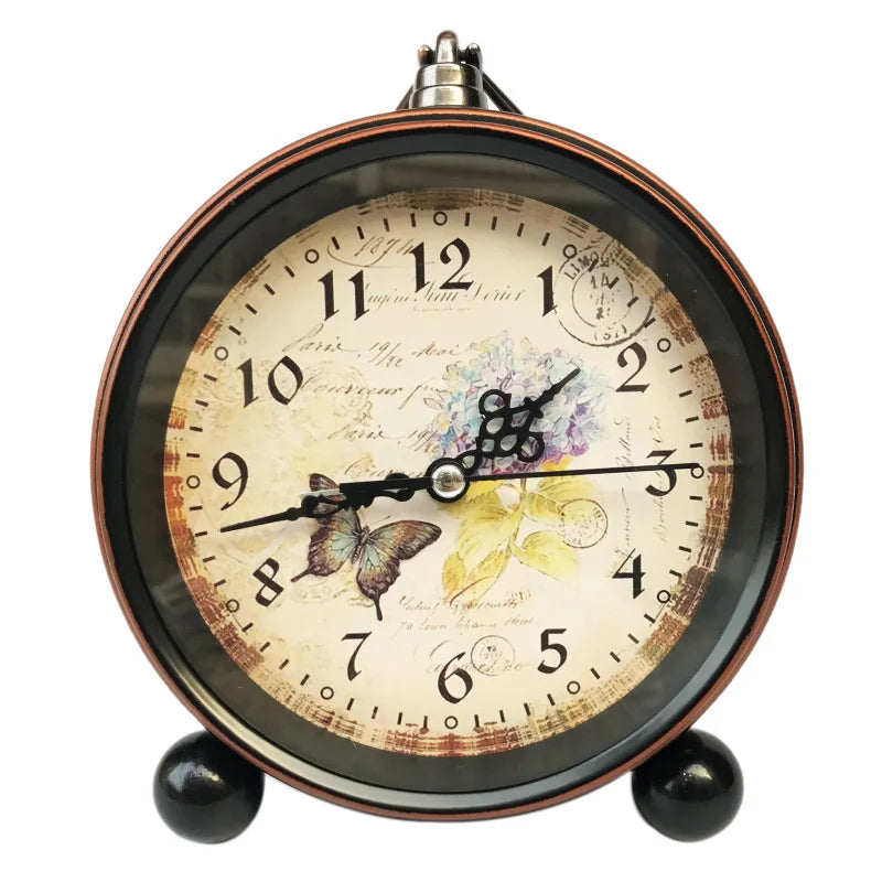 Vintage metal battery alarm clock night light with an antique face and dark frame.