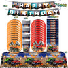 Monster truck birthday party decoration kit featuring a banner, plates, and a backdrop with toy trucks.