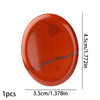 A polished, oval piece of reddish-orange natural stone with gray veining.