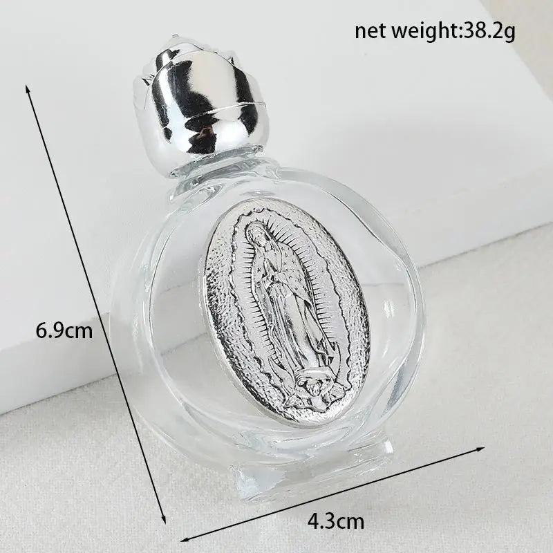 A clear glass bottle containing a silver-colored figurine, with dimensions and net weight indicated.