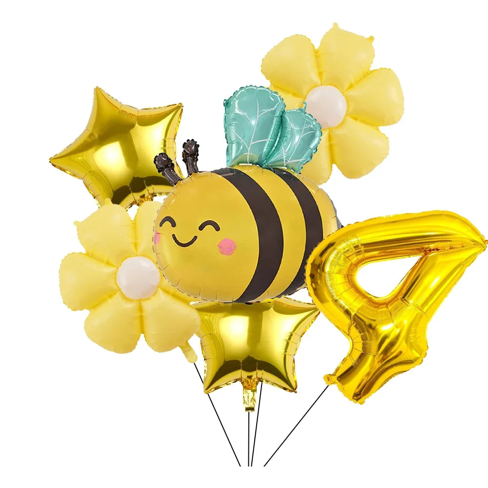 A set of six yellow and gold aluminum foil daisy balloons, including a bee balloon with green accents.