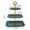 A three-tier plastic dessert stand with gold accents, featuring green scalloped plates.