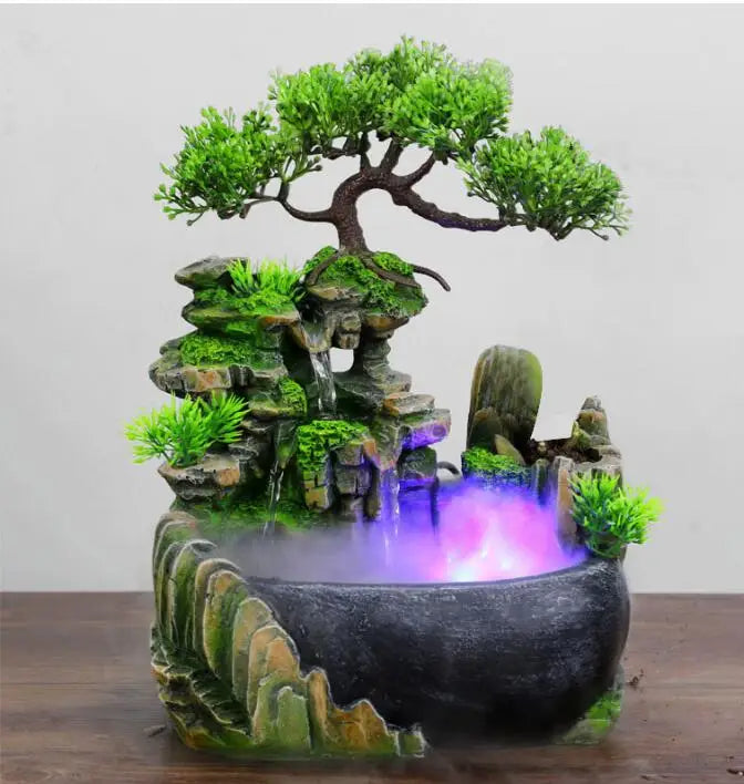 Resin waterfall desktop fountain with LED lighting featuring a mossy rock landscape and glowing purple water.