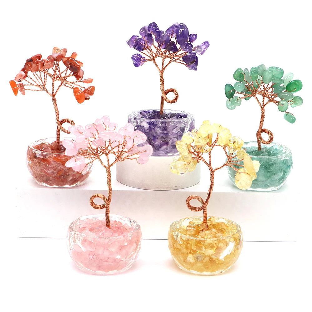 A collection of crystal healing gemstone bonsai trees in various colors including pink, purple, green, and orange.