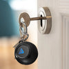 A black magic 8 ball keychain with a blue triangle symbol attached to a silver metal keyring.