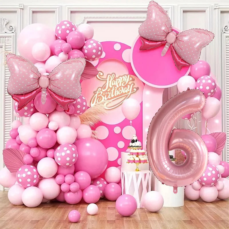 A pink and white balloon garland arch kit featuring numerous balloons in various shades of pink and white.