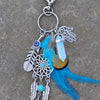 Silver bohemian dream catcher keychain featuring a blue feather and decorative elements