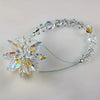 A sparkling crystal star suncatcher ornament attached to a silver-toned wire bracelet.