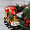 A detailed battery-powered railway train toy with red and black body, gold accents, and a white grille on a track.