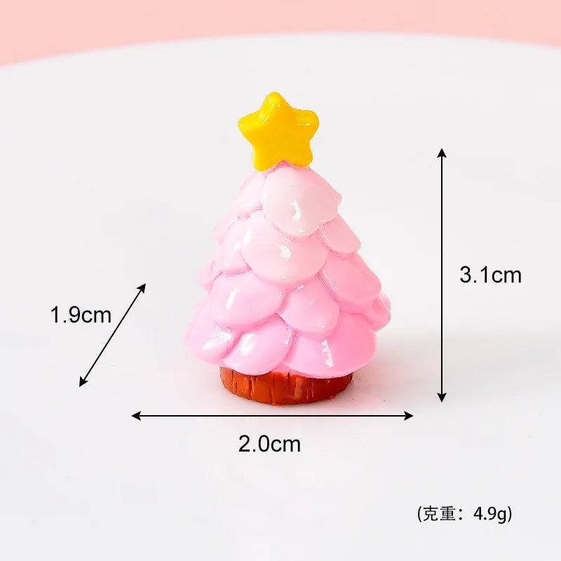 A small pink and yellow resin charm shaped like a Christmas tree with a star topper.