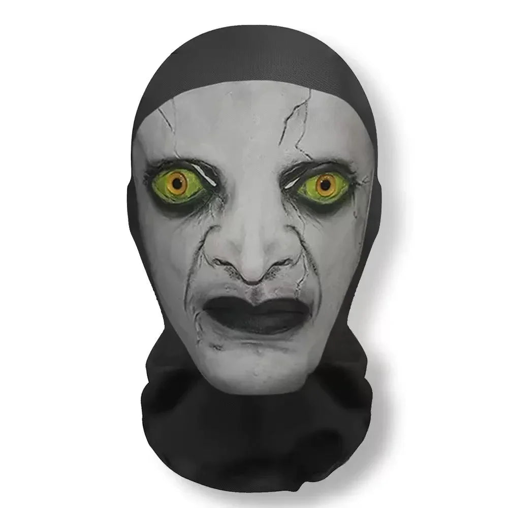 A grayscale mask resembling a face with cracked skin and glowing yellow eyes, worn as carnival headgear.