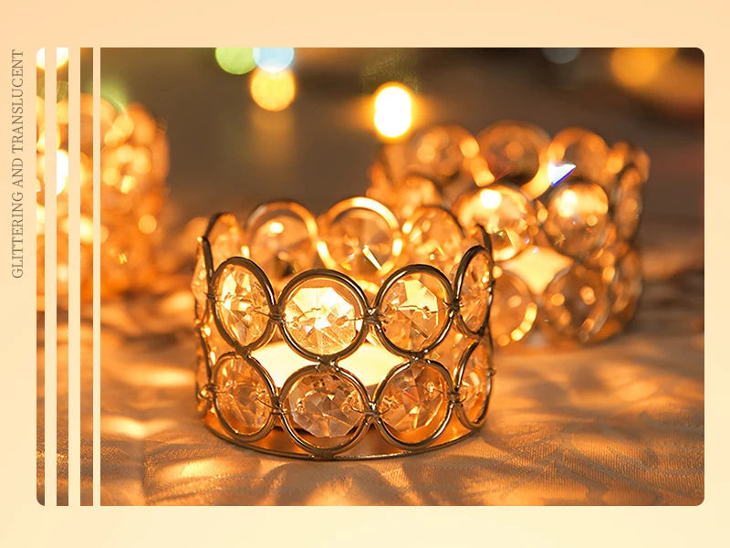 A close-up of a set of gold crystal votive candle holders glowing warmly on a surface.