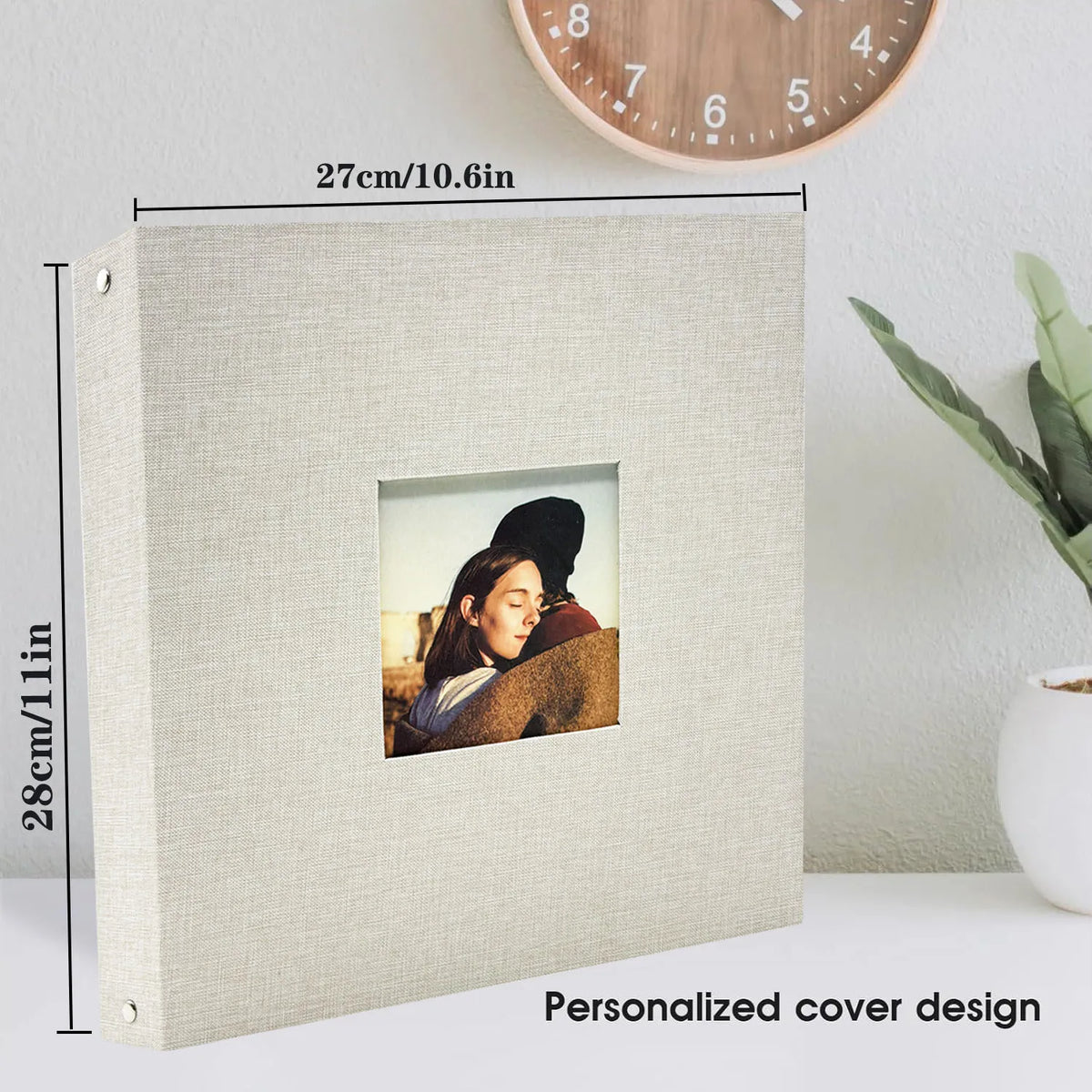 A personalized linen cover for a scrapbook album with a square window displaying a photo.
