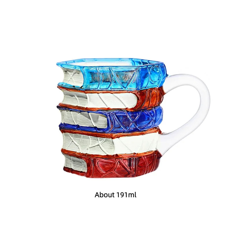 A stack of hand-painted mugs featuring various book designs in shades of blue, orange, and white.