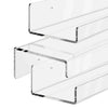 A set of clear acrylic floating display shelves mounted on a wall.