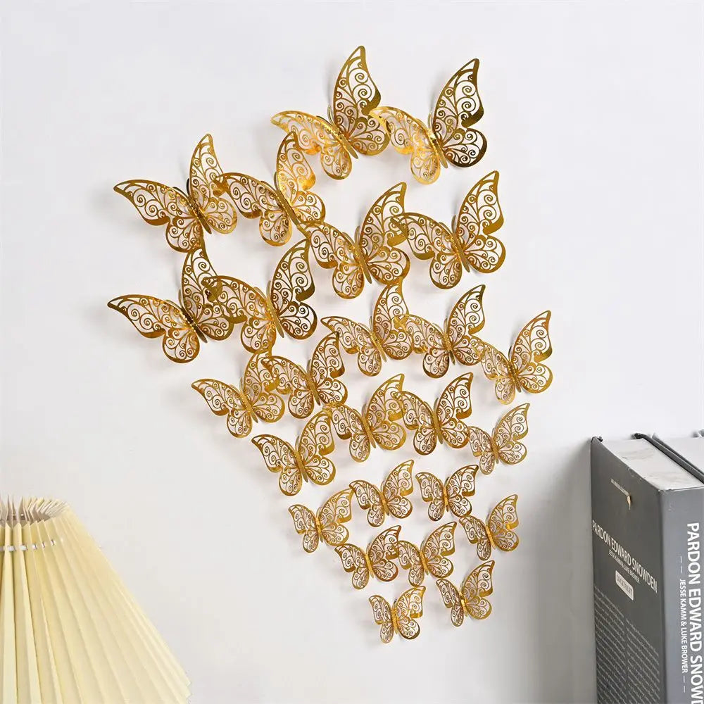 A set of 3D hollow gold butterfly wall decals mounted on a white wall.