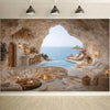 A luxurious, natural cave-like setting with a blue pool and lounge area overlooking the sea.