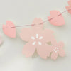Pink paper cherry blossom flag banner with heart shapes and white flower cutouts