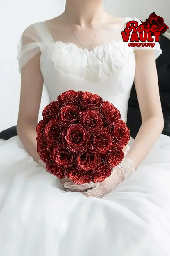 A close-up of a bouquet of deep red glitter artificial roses held by a person.