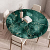 A dark teal marble print waterproof round tablecloth displayed on a wooden table with modern chairs.