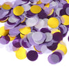 A pile of round tissue paper confetti dots in shades of purple and yellow.