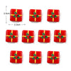Un juego de imanes navideños rojos con detalles de hiedra verde.