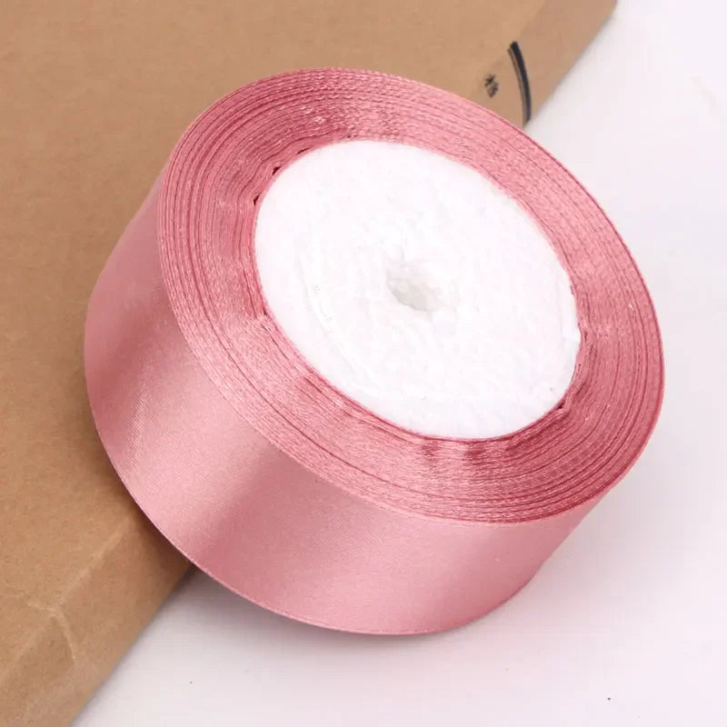 Roll of pink satin ribbon for crafts and gift wrapping