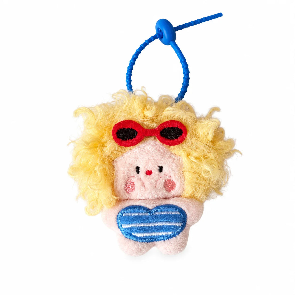 A yellow fluffy plush animal with red glasses and a blue heart patch attached to a blue string keychain.