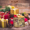 A collection of wrapped gifts, including boxes and a photo scrapbook album, decorated with ribbons and natural elements like 